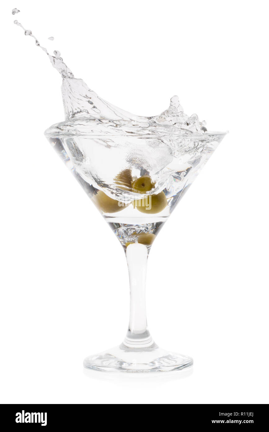 Splash of martini with olives in cocktail transparent glass on t Stock