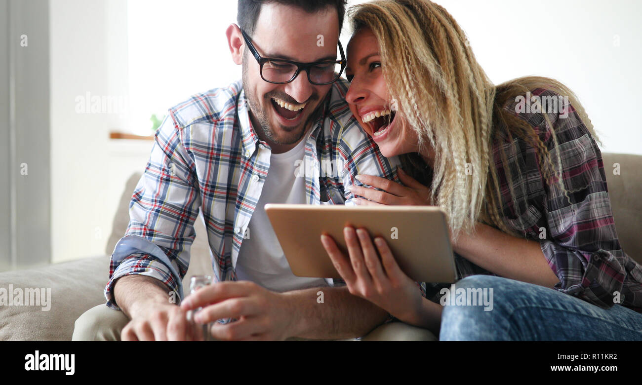 Happy couple in love surfing on tablet at home Stock Photo