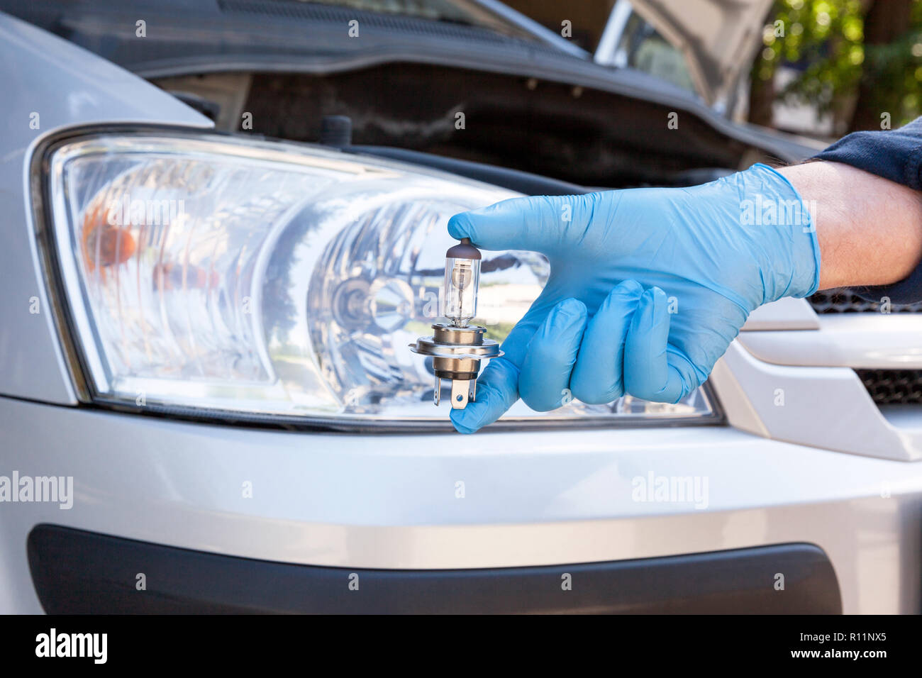 Changing halogen bulb in car headlight Stock Photo - Alamy