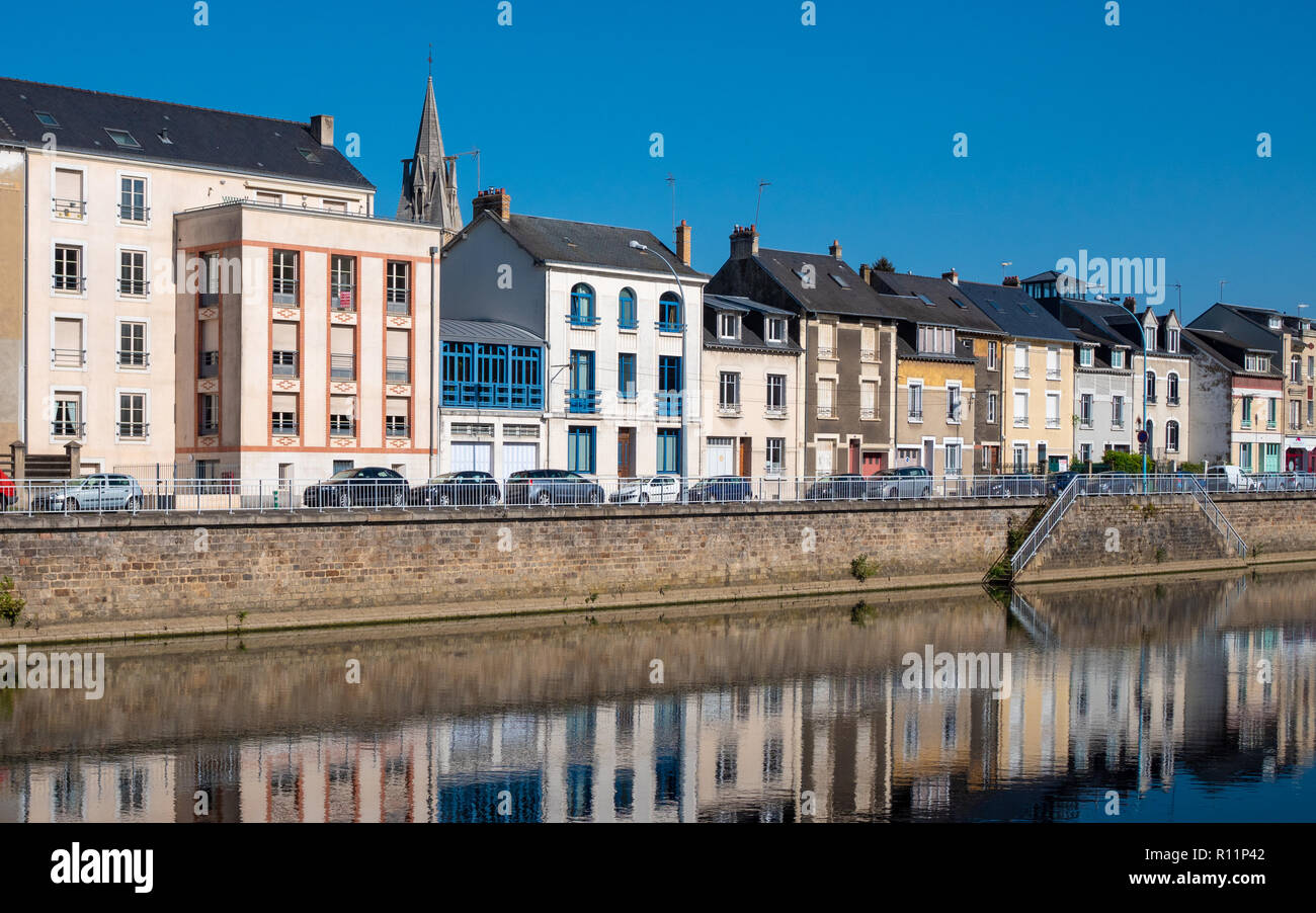 Buildings are reflected on the Sarthe River in the city of Le Mans in western France. Le Mans is an important city in the Pays de la Loire region. Fil Stock Photo