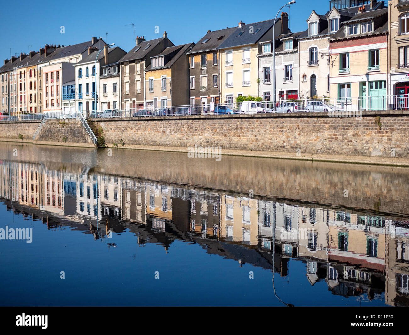 Buildings are reflected on the Sarthe River in the city of Le Mans in western France. Le Mans is an important city in the Pays de la Loire region. Fil Stock Photo