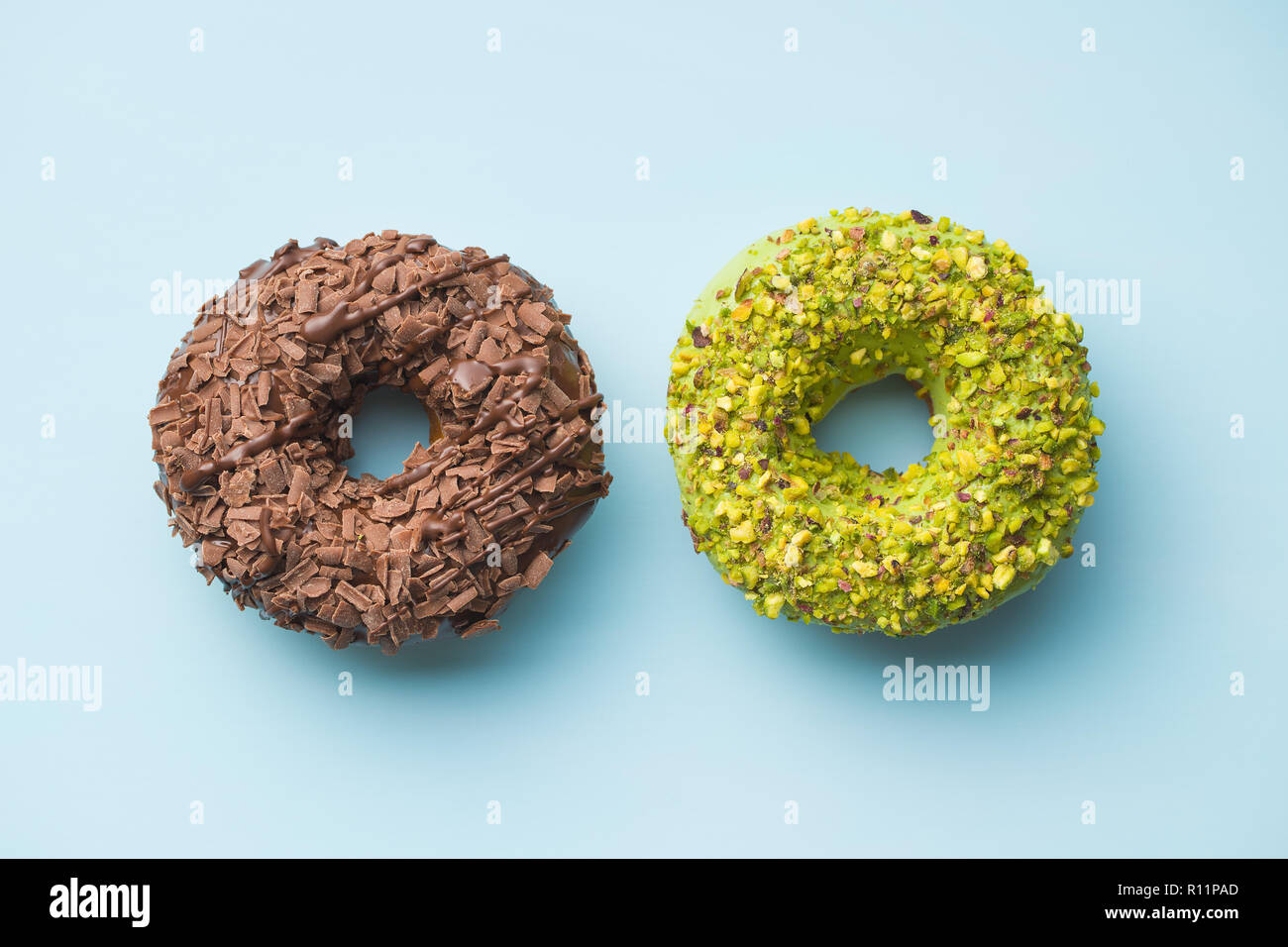 Sweet glazed donuts on blue background. Stock Photo