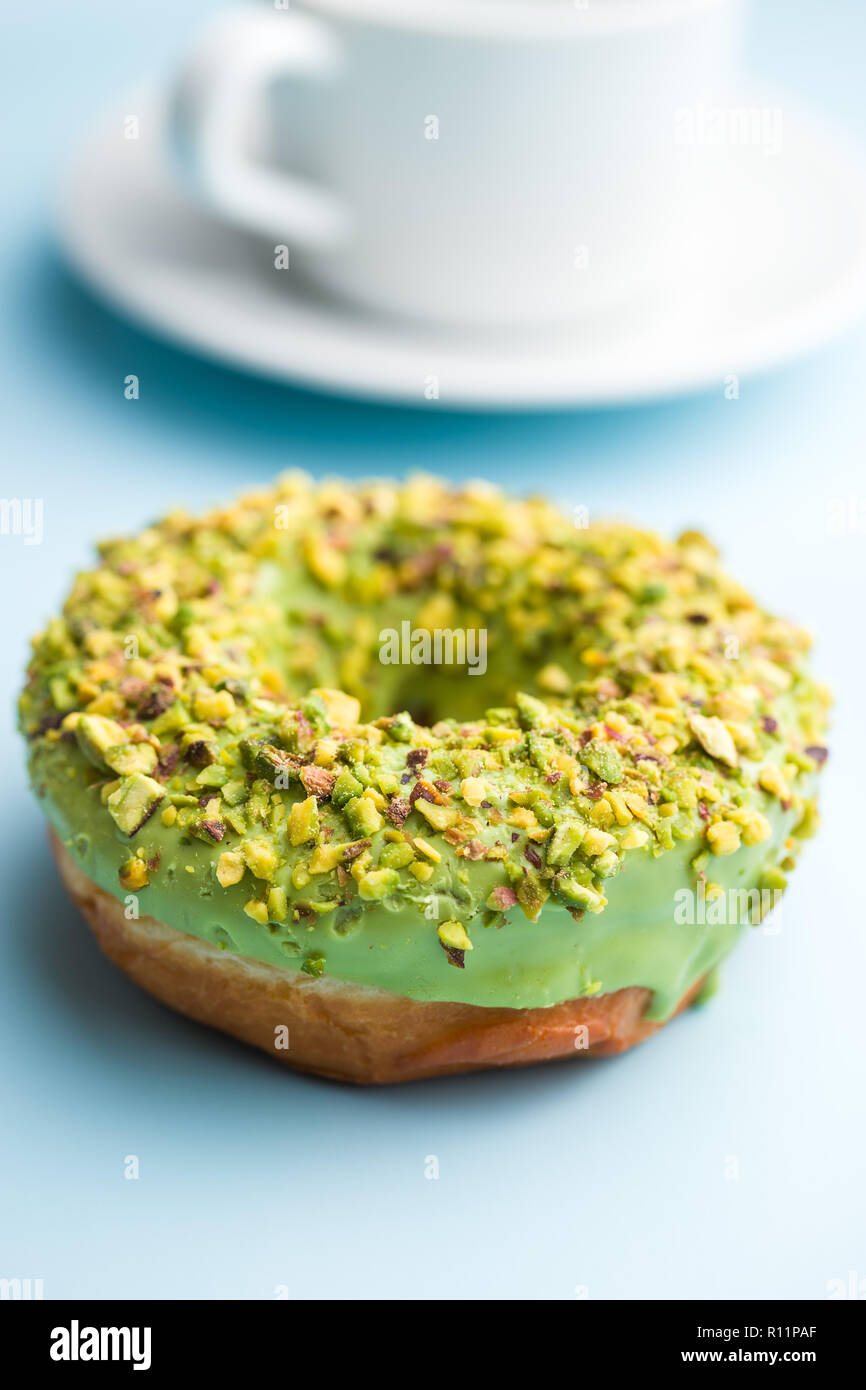 Sweet glazed donut on blue background. Stock Photo