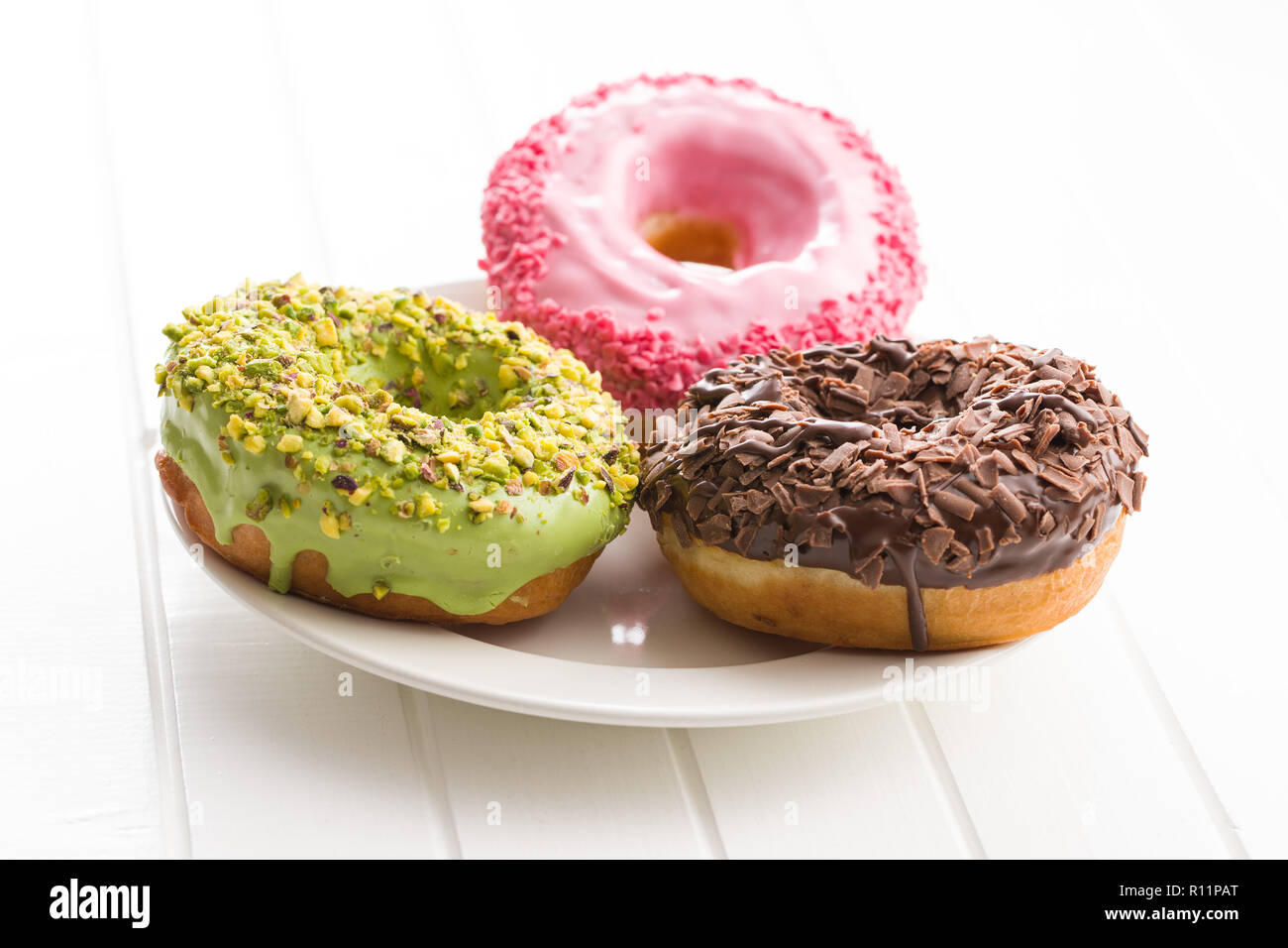 Three sweet donuts on plate. Stock Photo