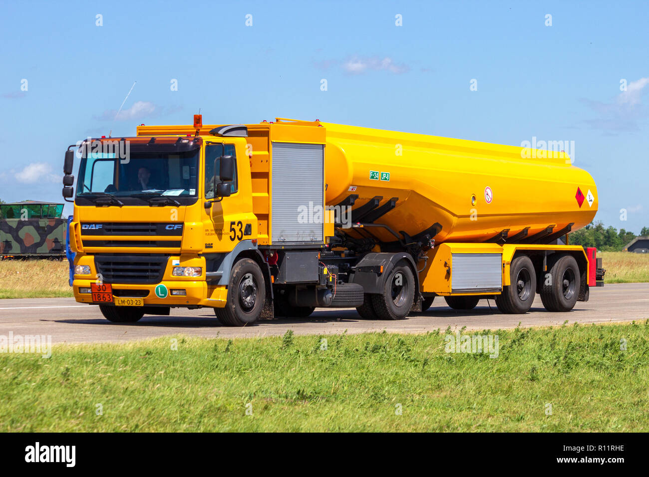 VOLKEL, THE NETHERLANDS - JUN 15, 2013: Mobile kerosine refueling vehicle driving on the taxi track of Volkel airbase Stock Photo