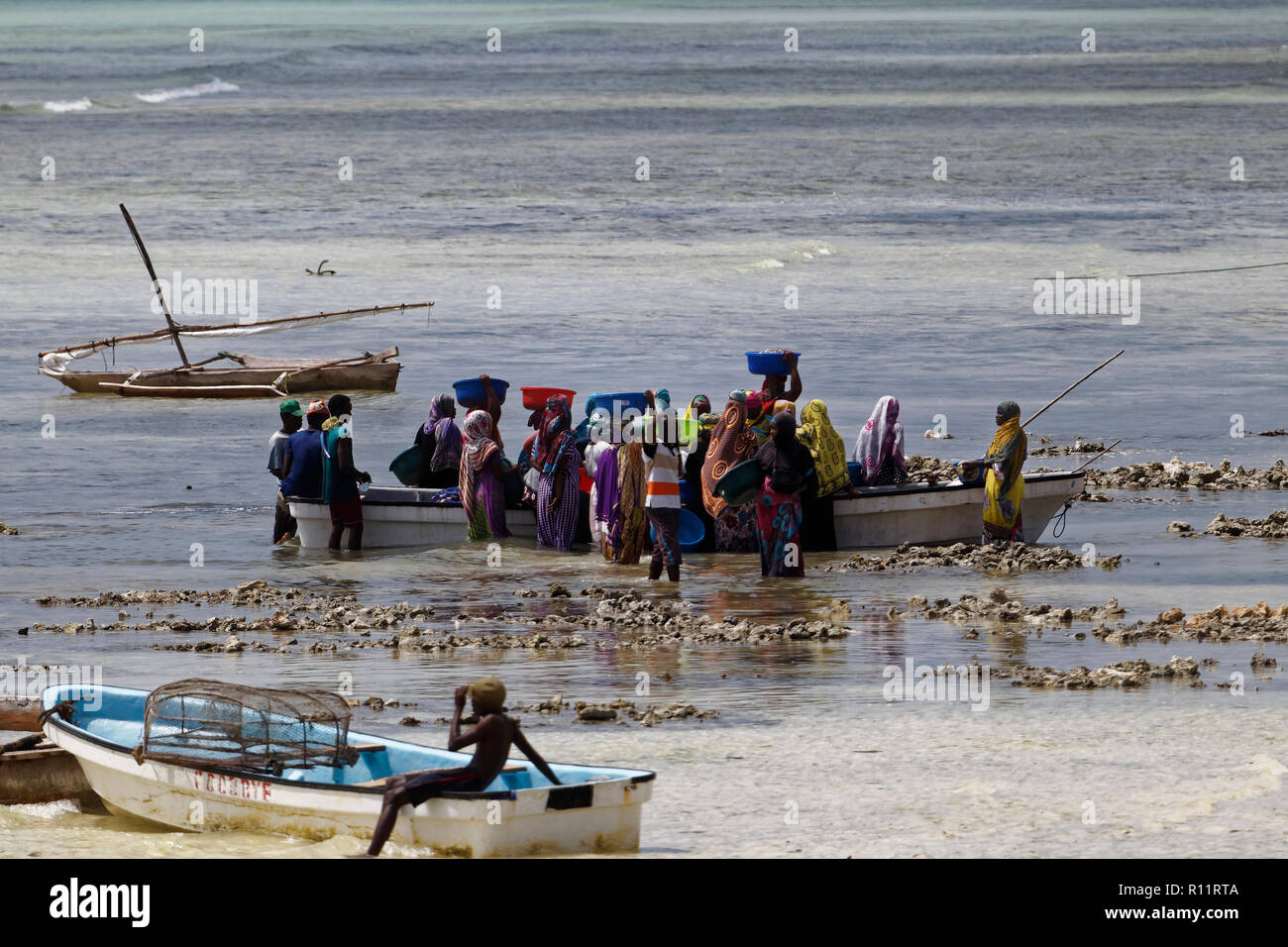 izimkazi, Zanzibar, Tanzania - January 19, 2018: Local people buying fish from fisherman. Kizimkazi village. Zanzibar, Tanzania. Stock Photo