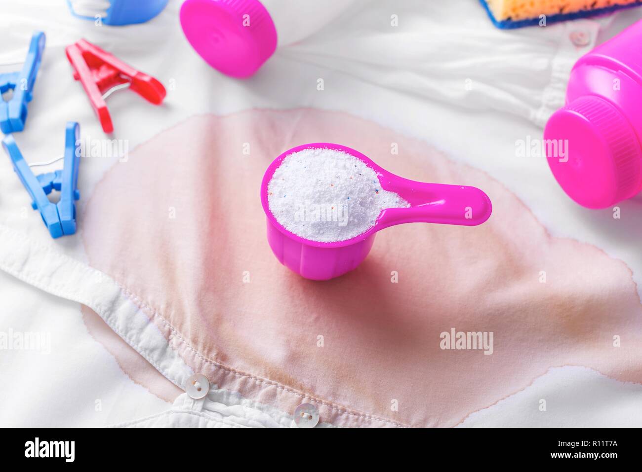Stain on clothes. Stain removers and other cleaning supplies. Stock Photo