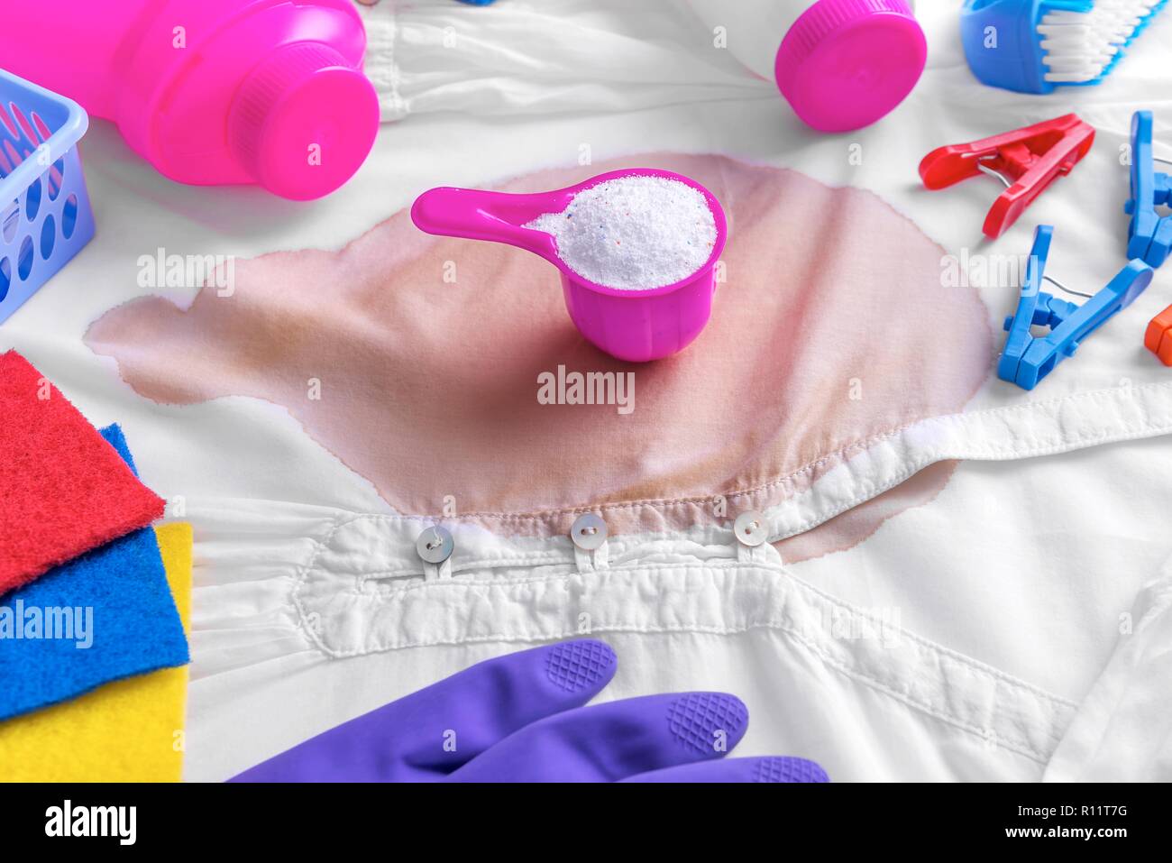 Stain on clothes. Stain removers and other cleaning supplies. Stock Photo