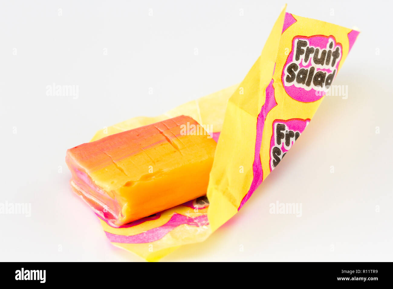 Fruit salad sweet, retro sweet, unwrapped, with wrapper, closeup Stock Photo