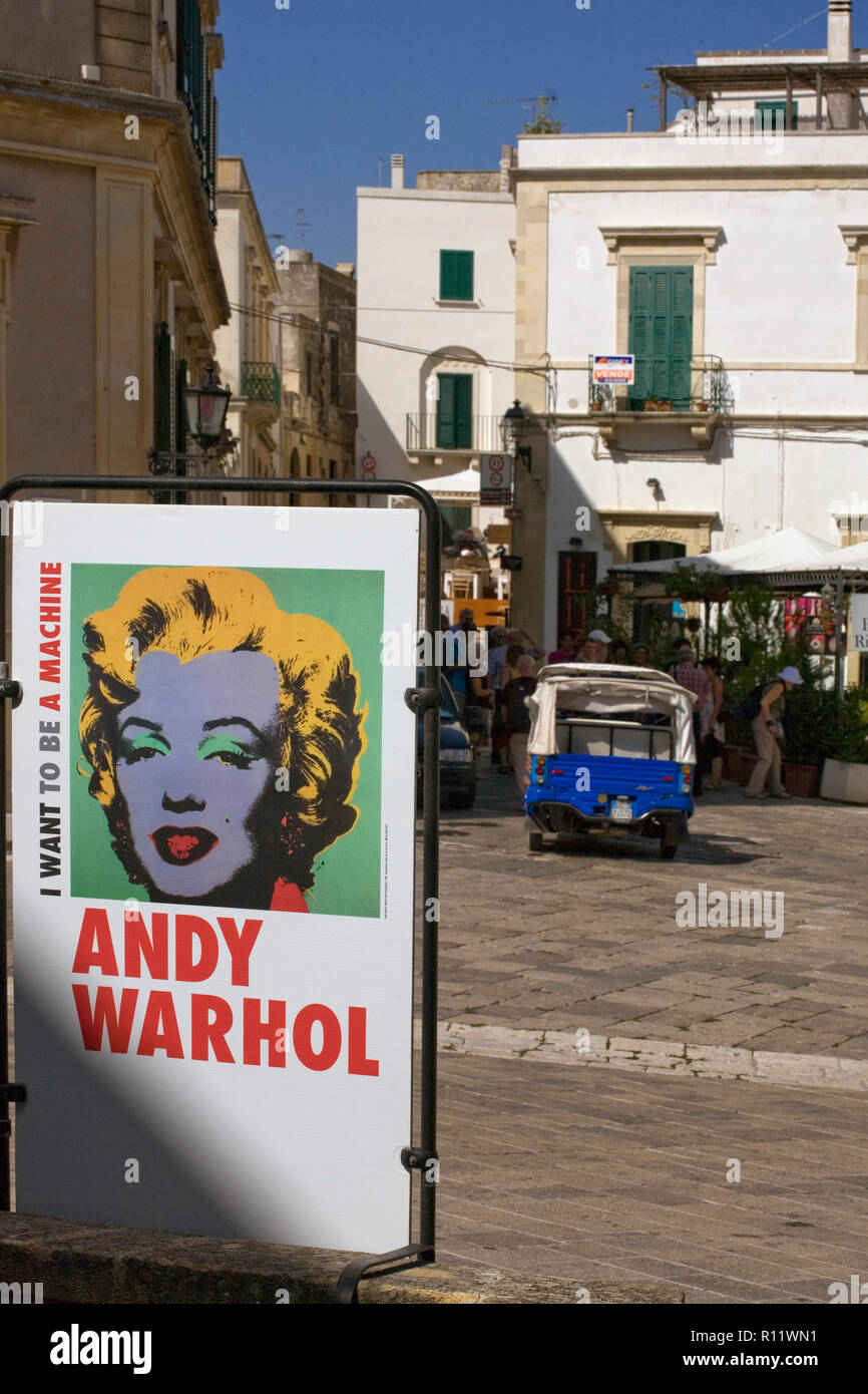 Piazza Alfonso d'Aragona, Otranto, Apulia, Italy: a poster advertising the Andy Warhol exhibition 'I Want to Be a Machine' Stock Photo