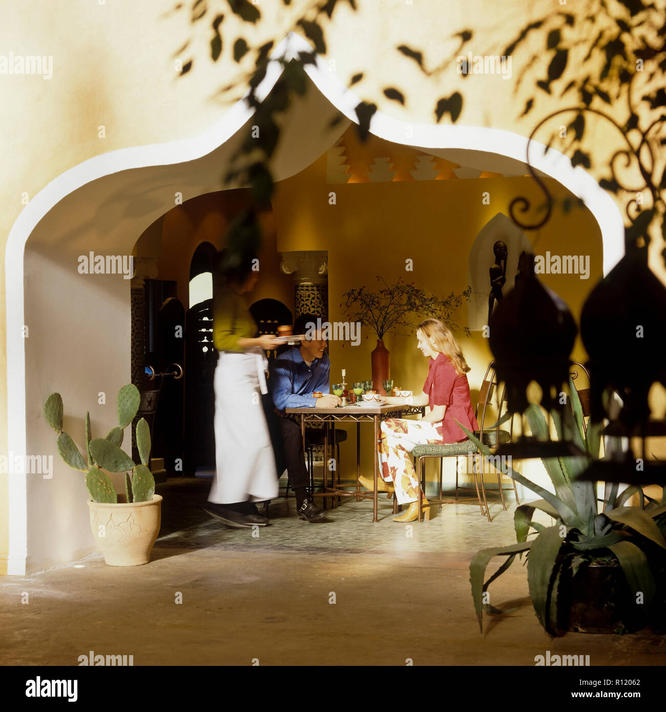 Man and woman sitting in an Arabic style restaurant Stock Photo