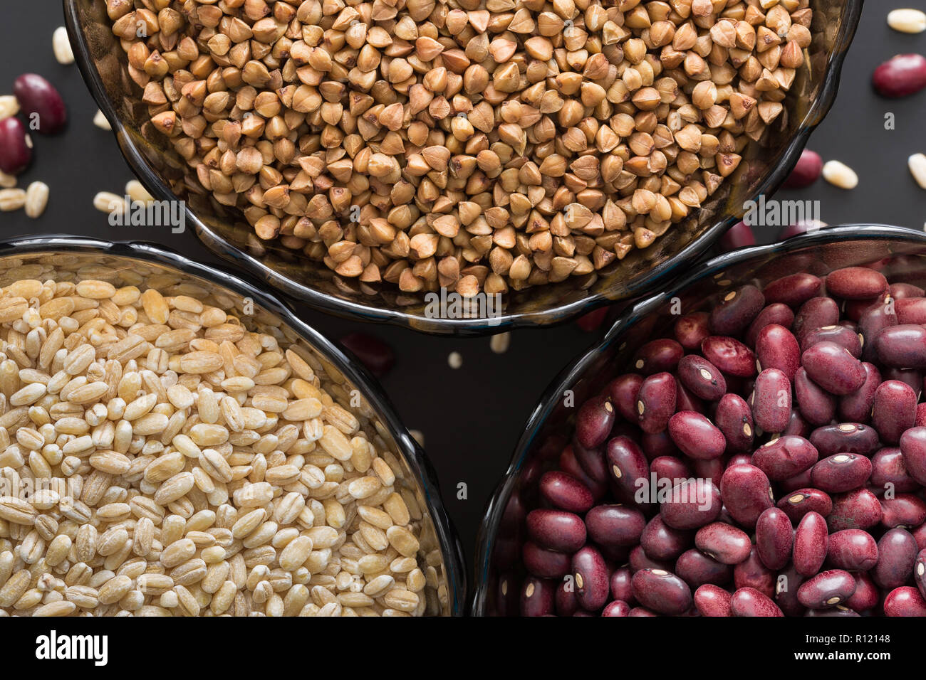 Three glass bowl with buckwheat groats, beans and barley Stock Photo