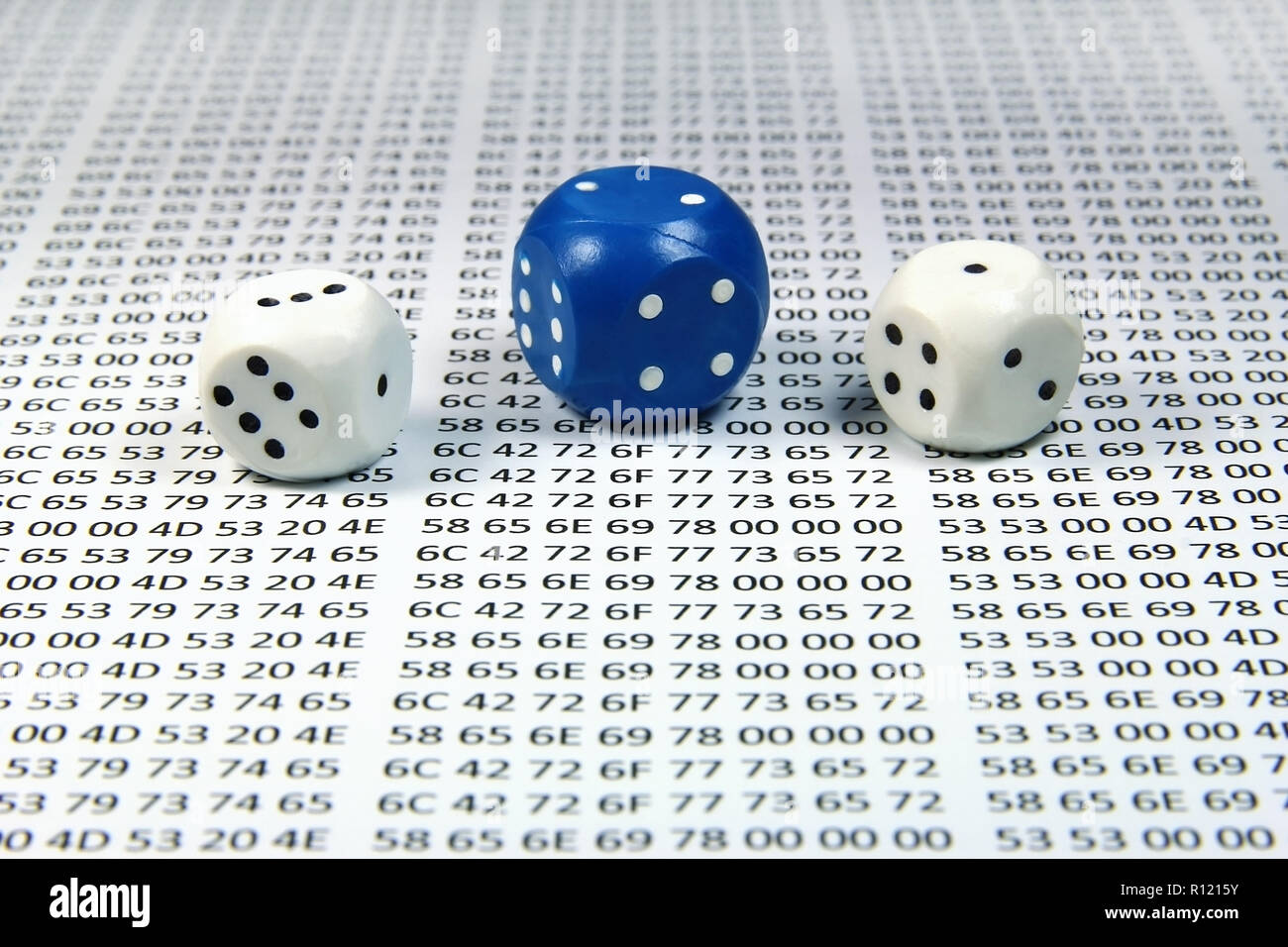 Multicolored dice against the hex codes closeup Stock Photo