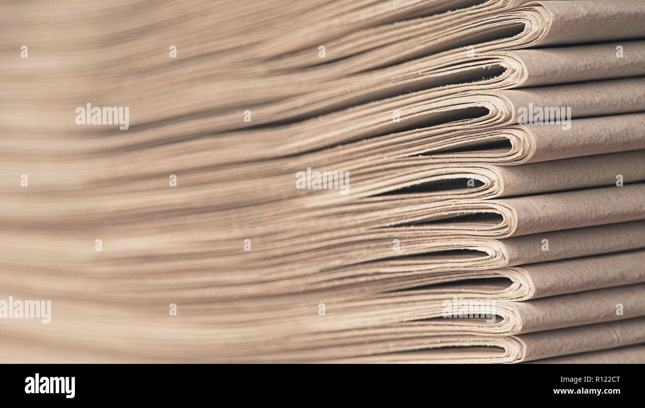 Stack of old newspapers - Soft focus with copy space. Stock Photo
