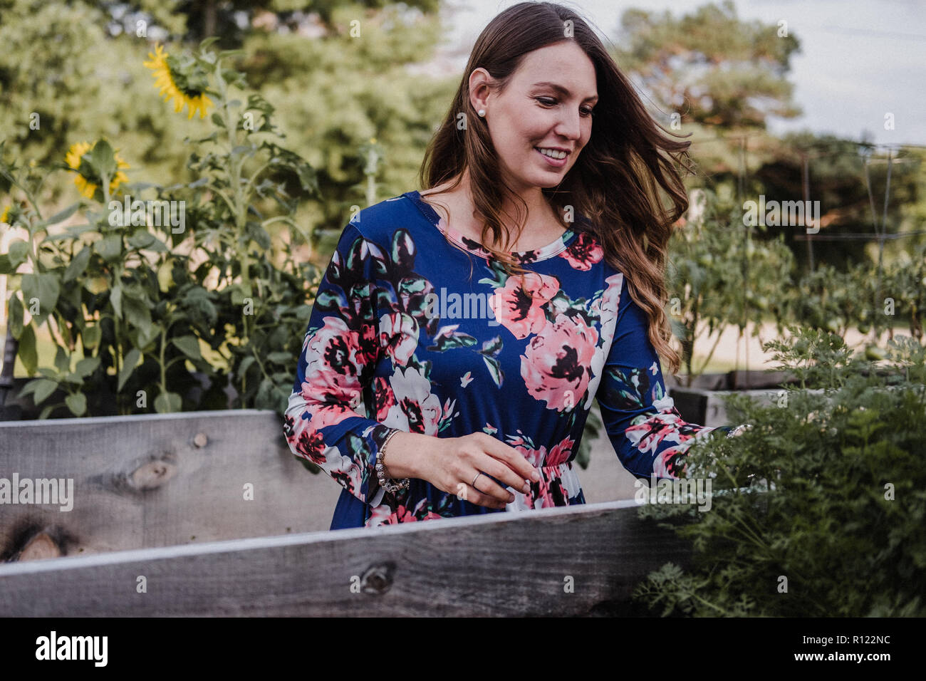 Woman checking on her plants Stock Photo