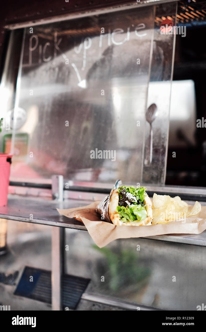 Food served through window of food truck Stock Photo