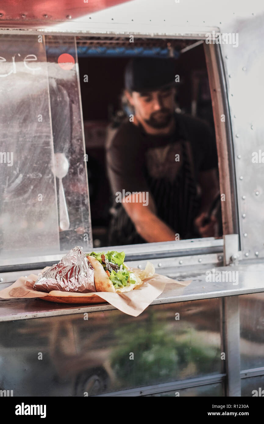 Man cooking in camper van food truck Stock Photo