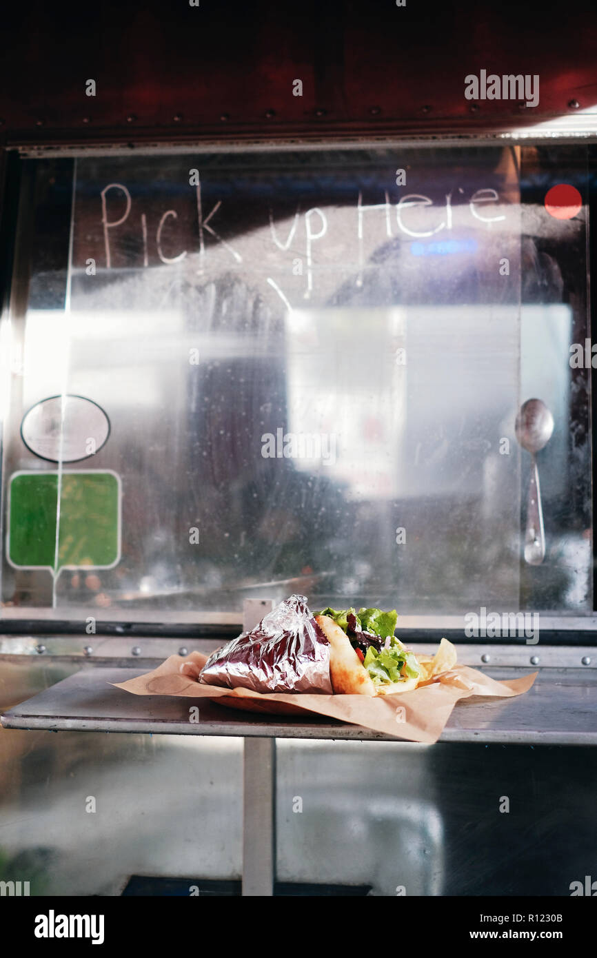 Food served through window of food truck Stock Photo