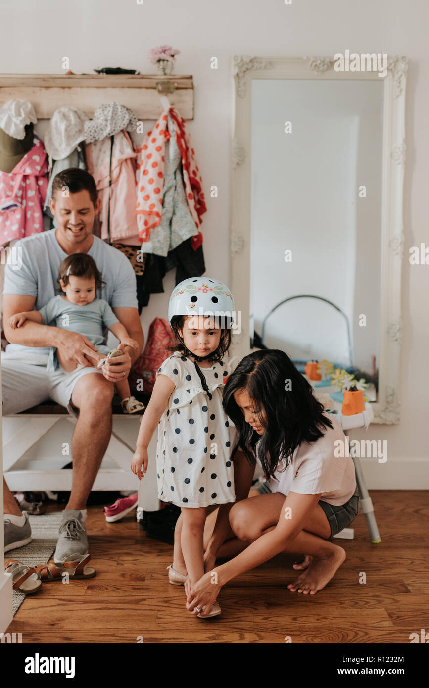 Family getting ready to go for walk and cycle Stock Photo