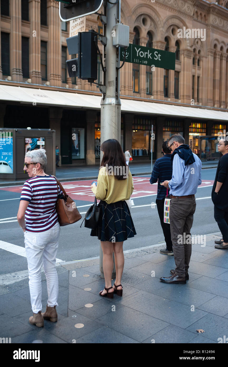 06.05.2018, Sydney, New South Wales, Australia - People are seen waiting at a pedestrian light in Sydney's central business district. Stock Photo
