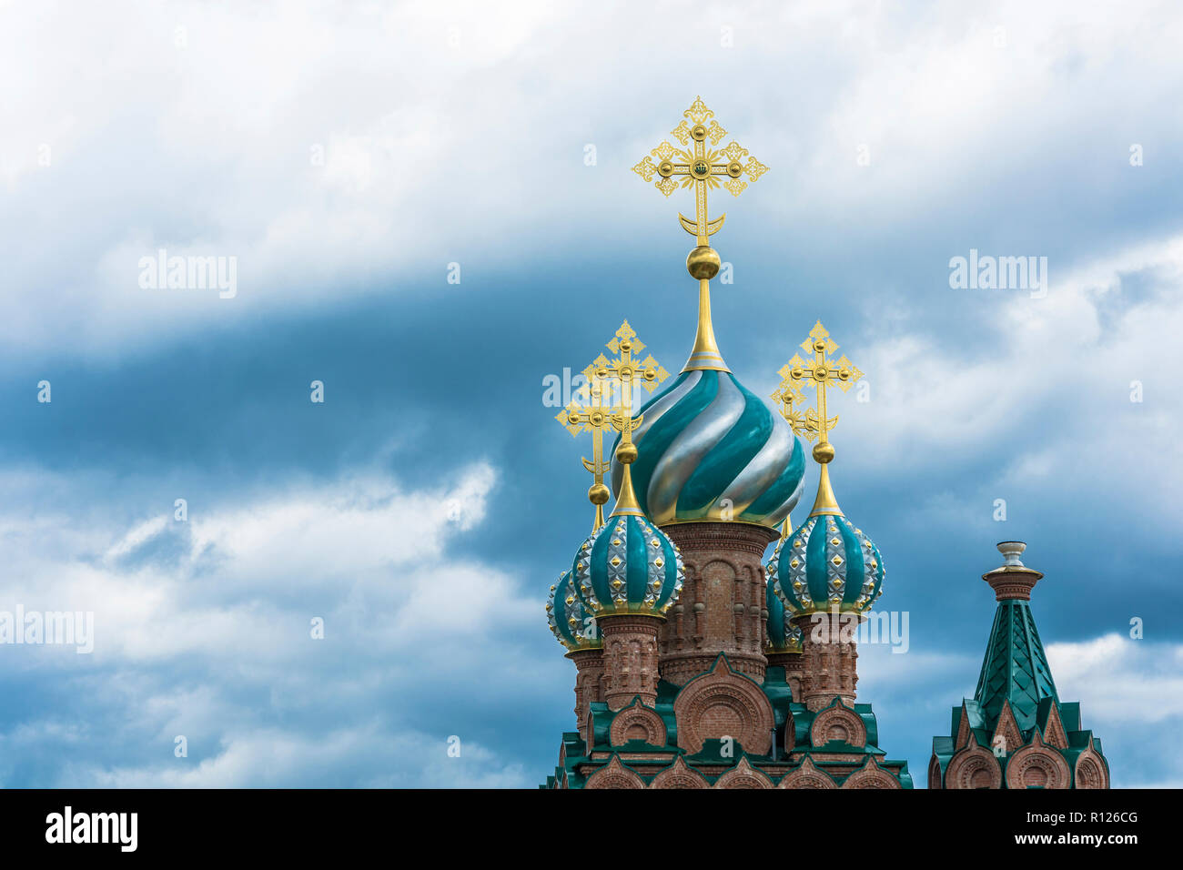 Beautiful church domes with gold crosses against a cloudy sky on a ...