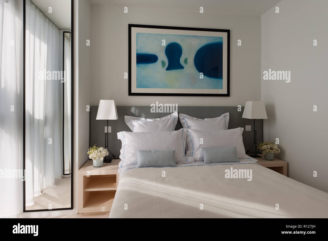 Modern painting over double bed Stock Photo Alamy