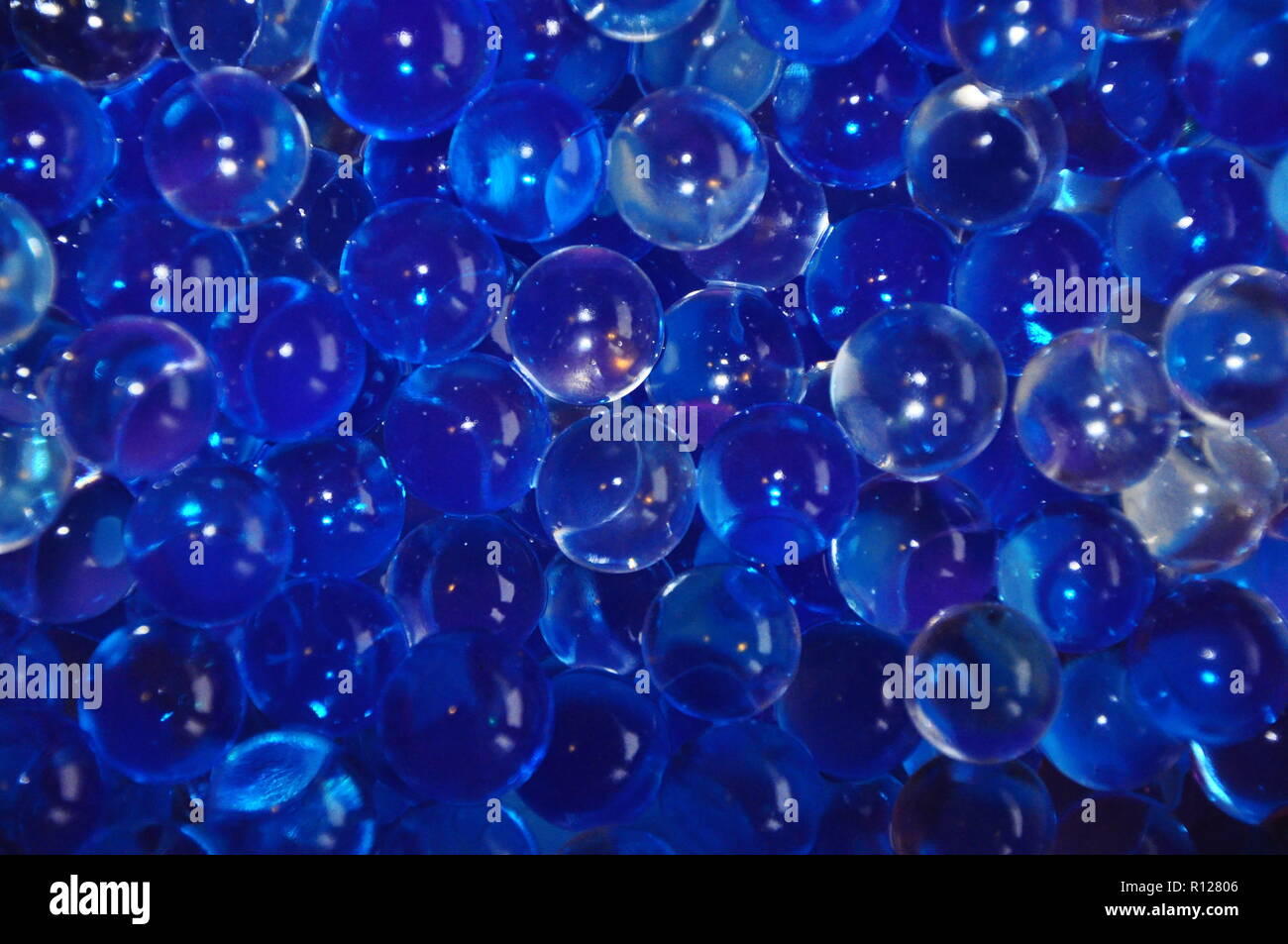 Gel bubbles blue colored on dark blue background Stock Photo