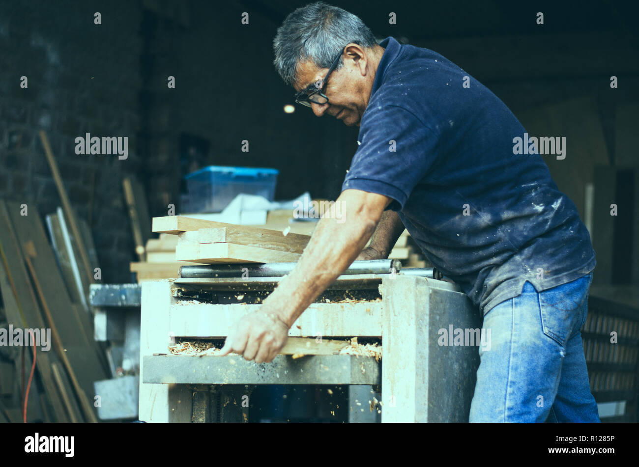 Carpenter using belt sander. Carpenter sanding a wood with belt sander