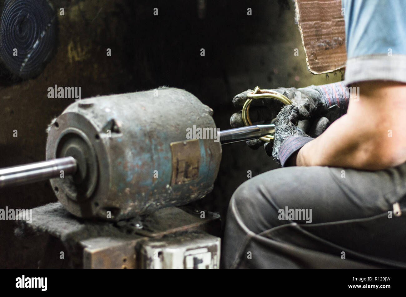 Precious parts polishing machine, Man polishing a jewel in the polisher