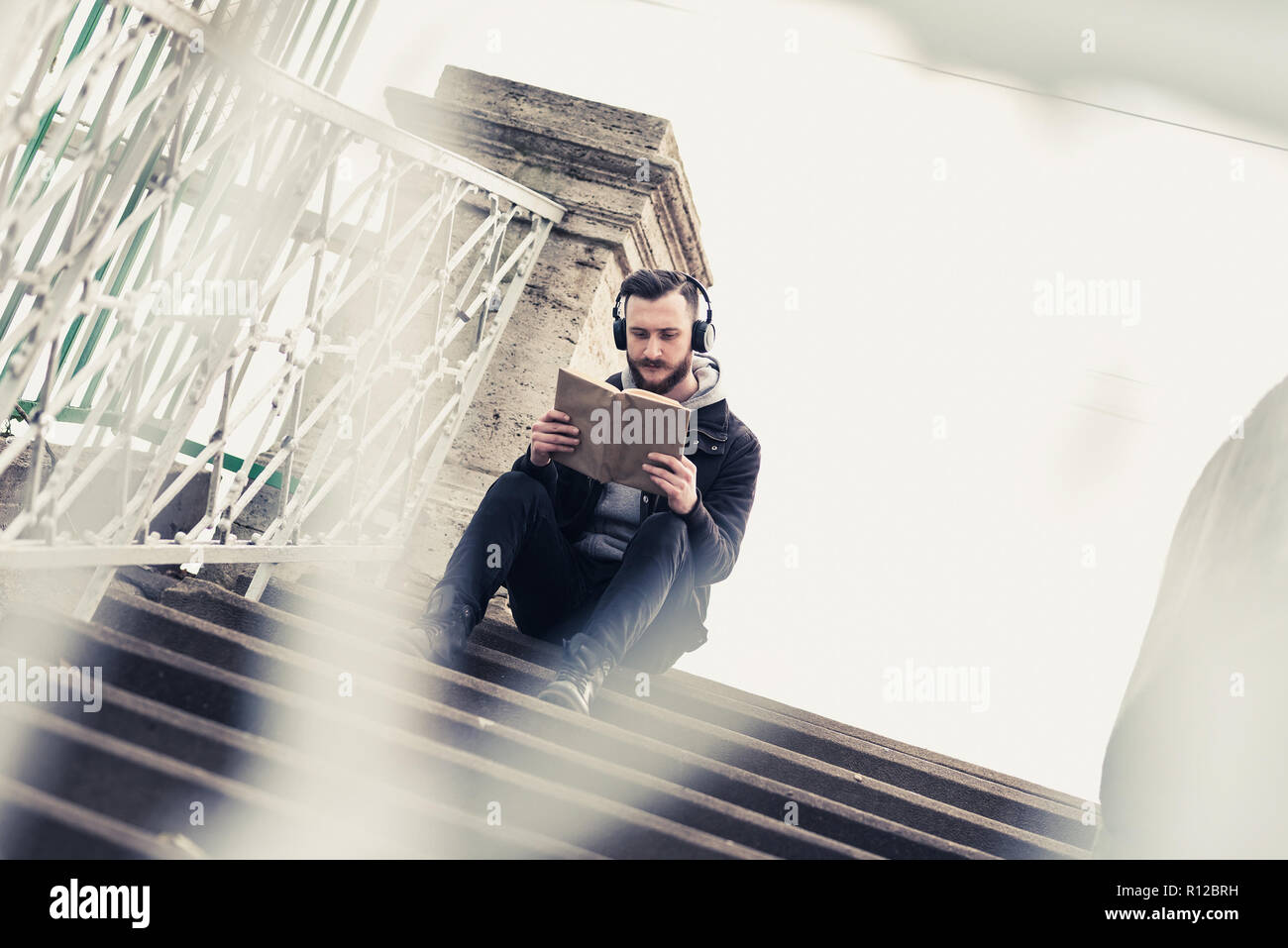 Man sitting on stairs book hi-res stock photography and images - Alamy