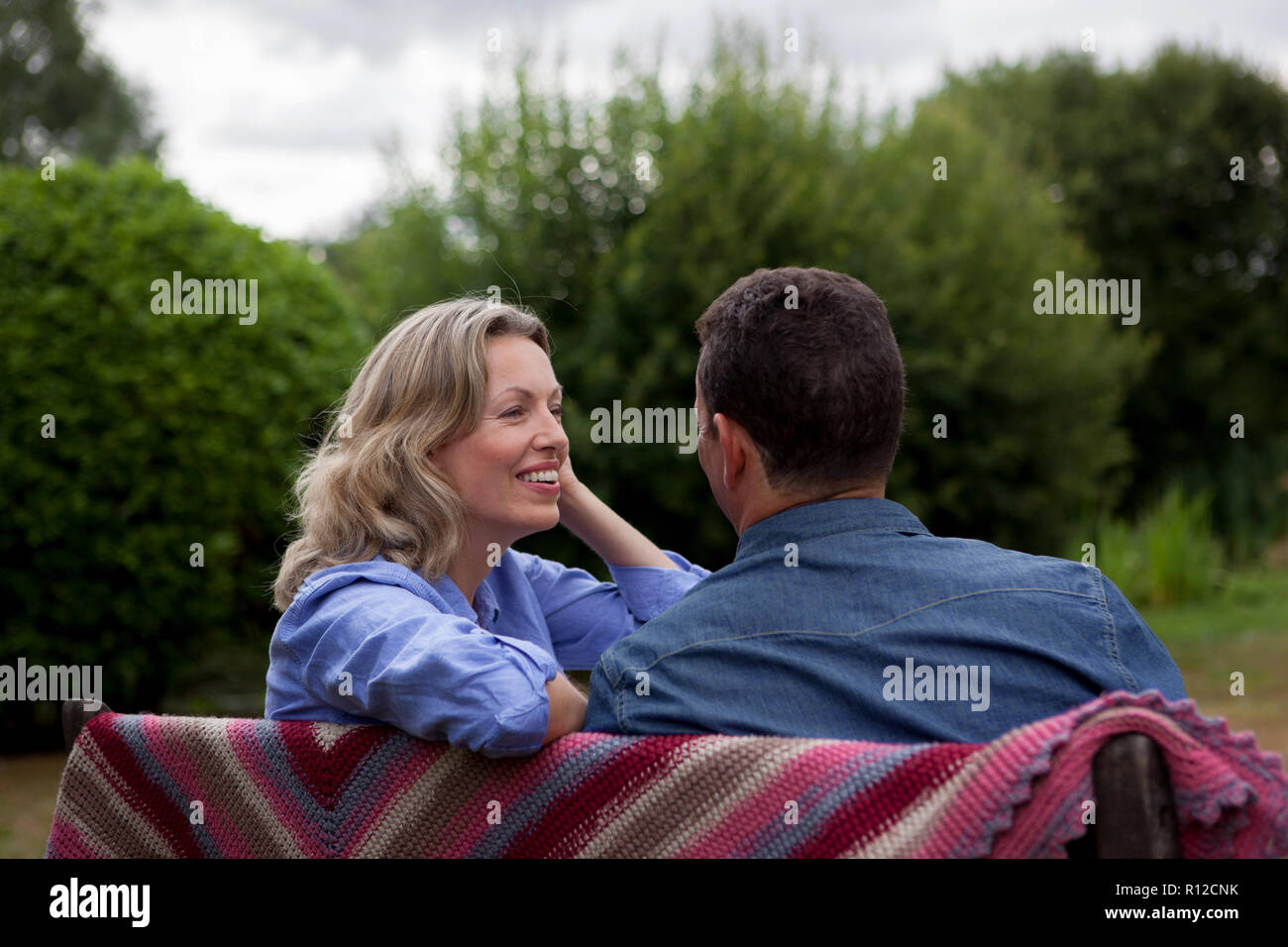 Mature couple sitting on garden bench Stock Photo - Alamy