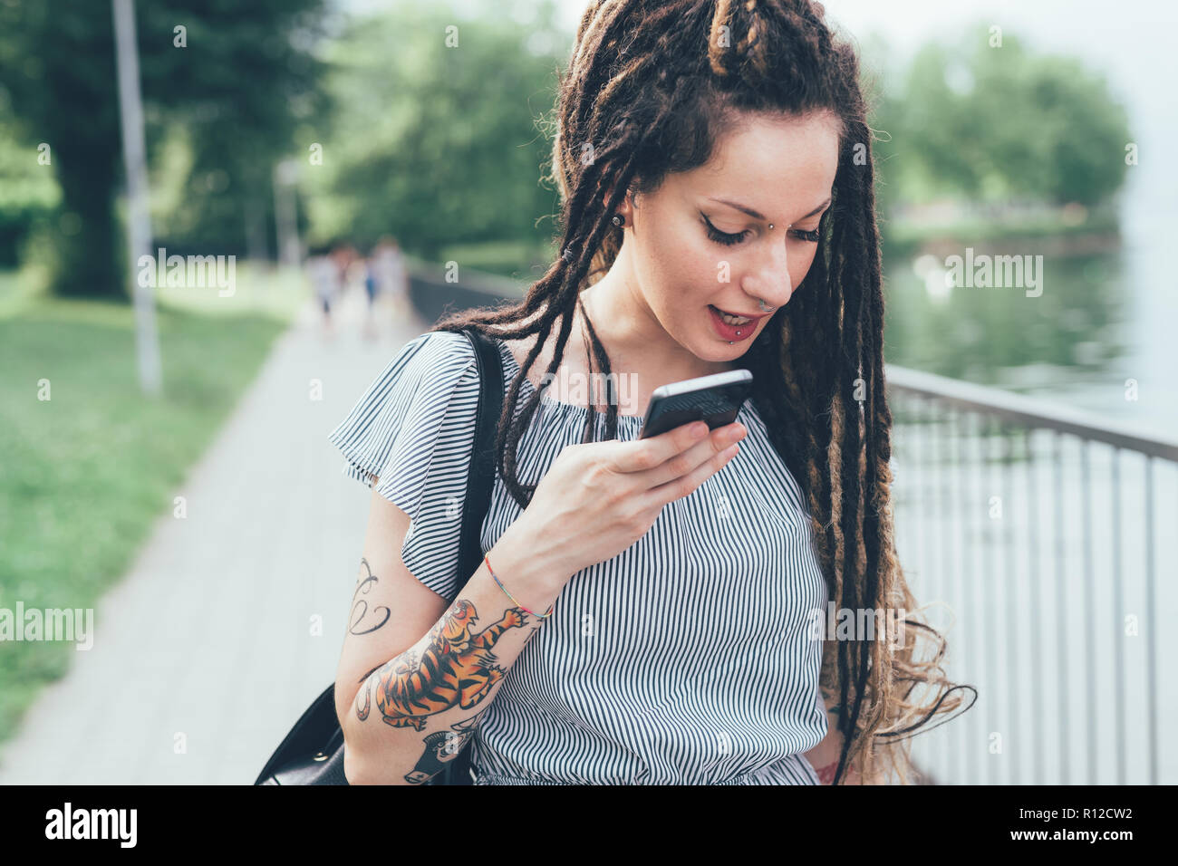 Woman using mobile phone in park Stock Photo