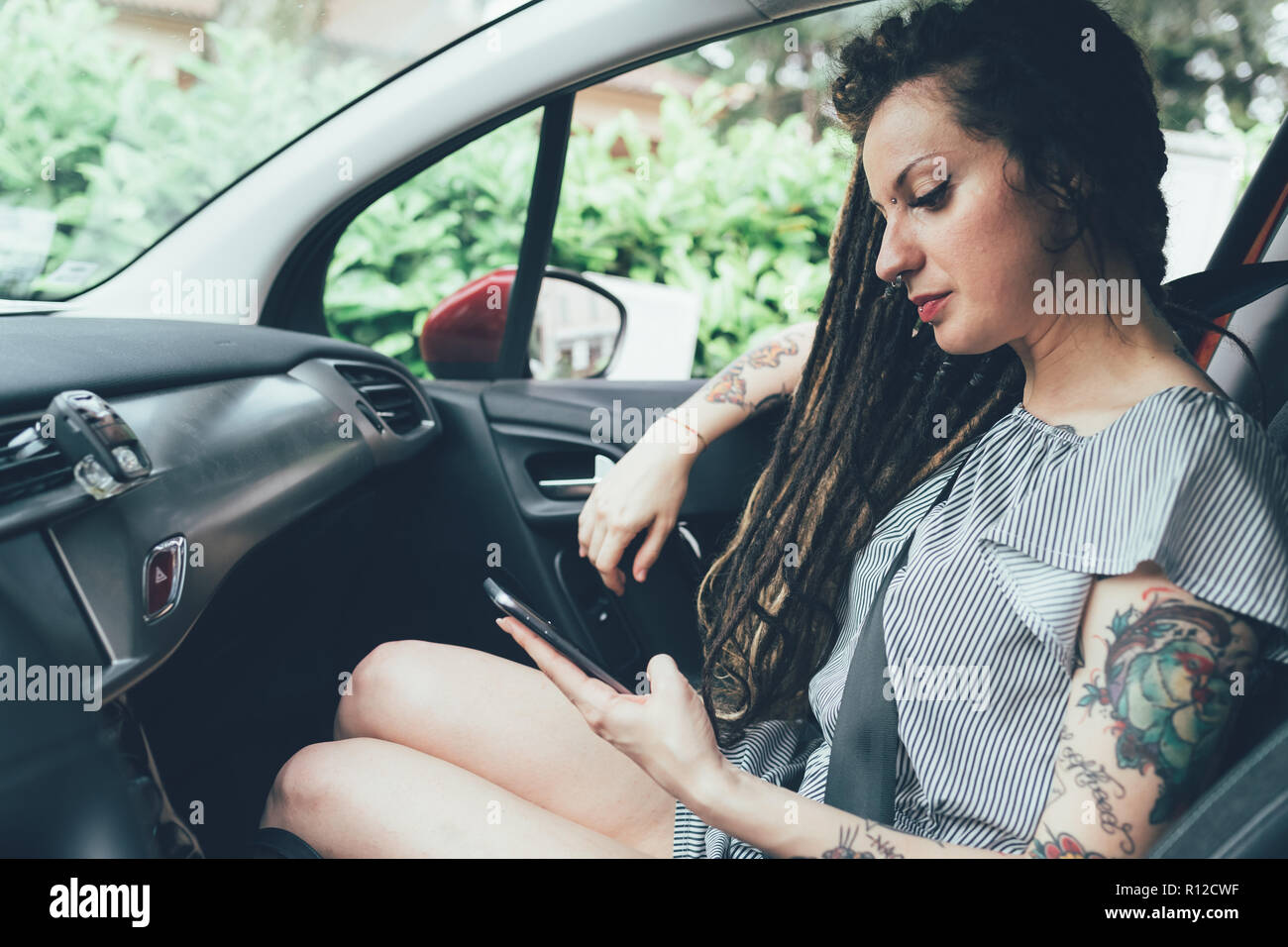 Woman using mobile phone in car Stock Photo