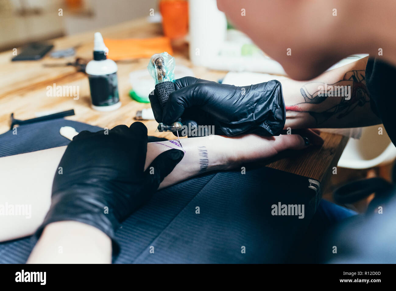 Tattooing an arm hi-res stock photography and images - Alamy