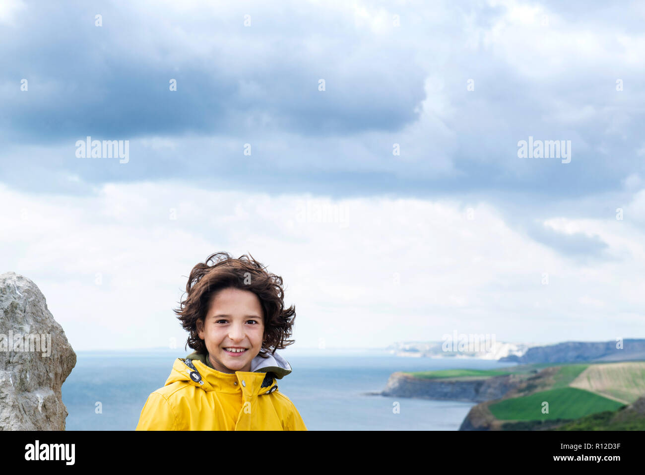 Boy on clifftop by sea, Bournemouth, UK Stock Photo