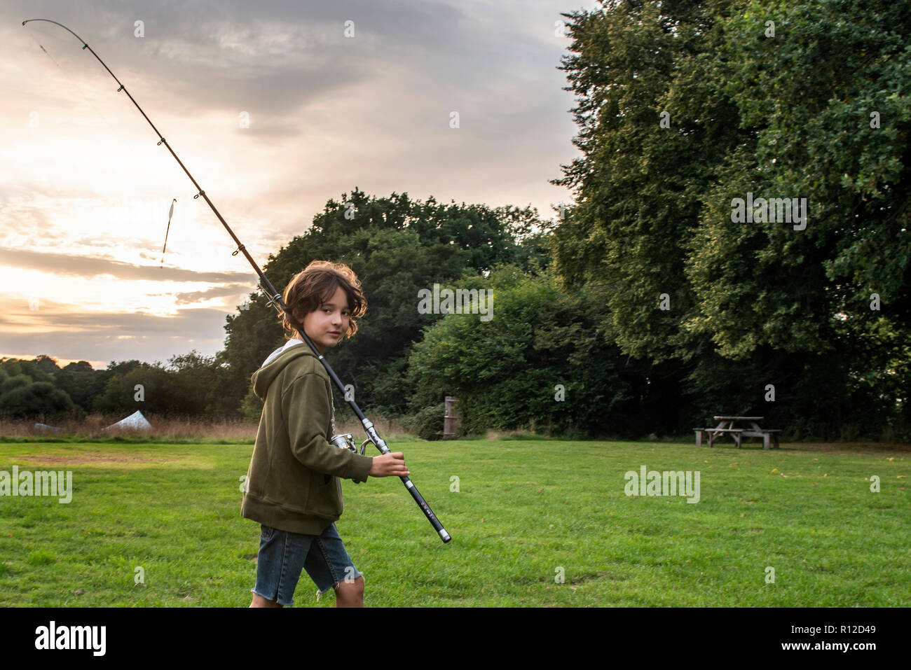 Boy carrying fishing rod on hi-res stock photography and images - Alamy
