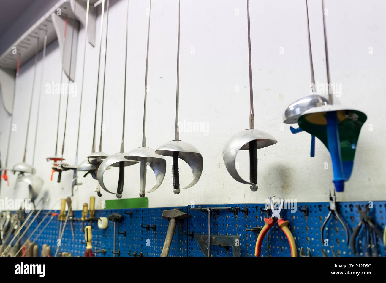 Fencing swords display in workshop Stock Photo