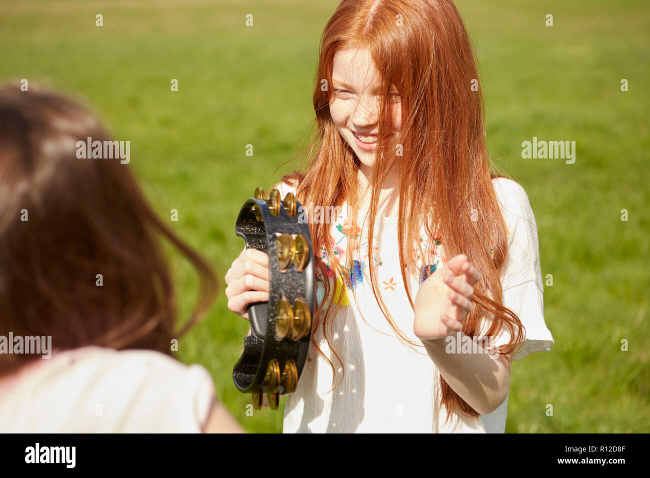 Girl playing tambourine Stock Photo Alamy