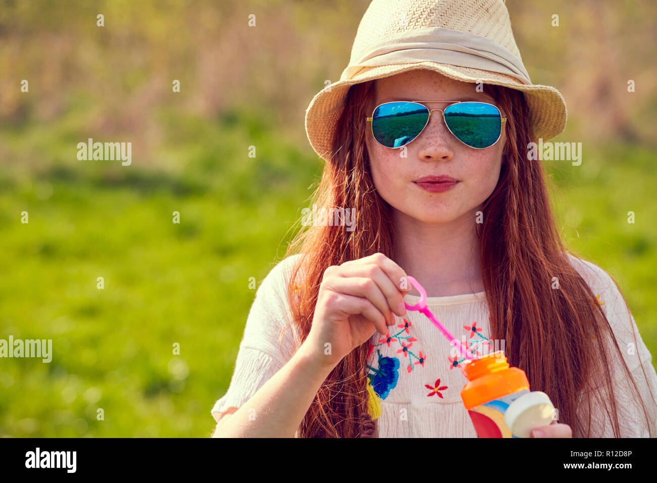 Girl playing with soap bubbles Stock Photo