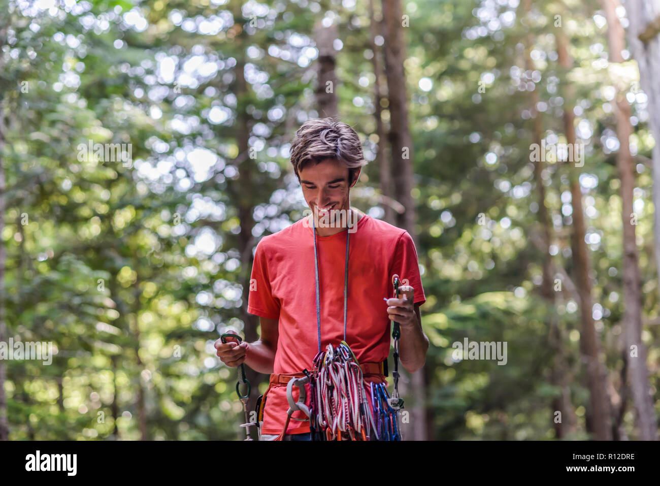 Happy rock climber in forest Stock Photo