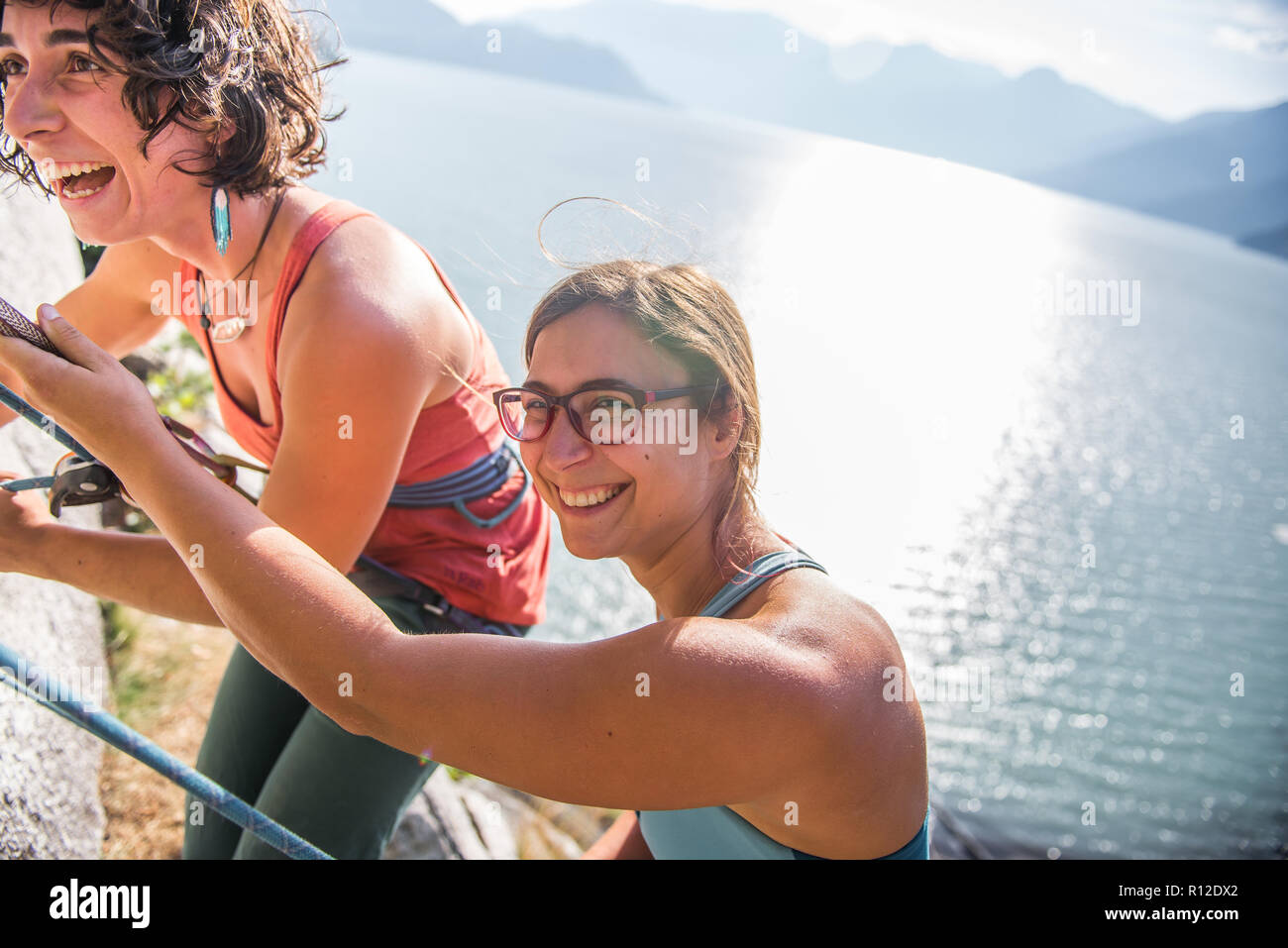 Girlfriends rock climbing, Malamute, Squamish, Canada Stock Photo