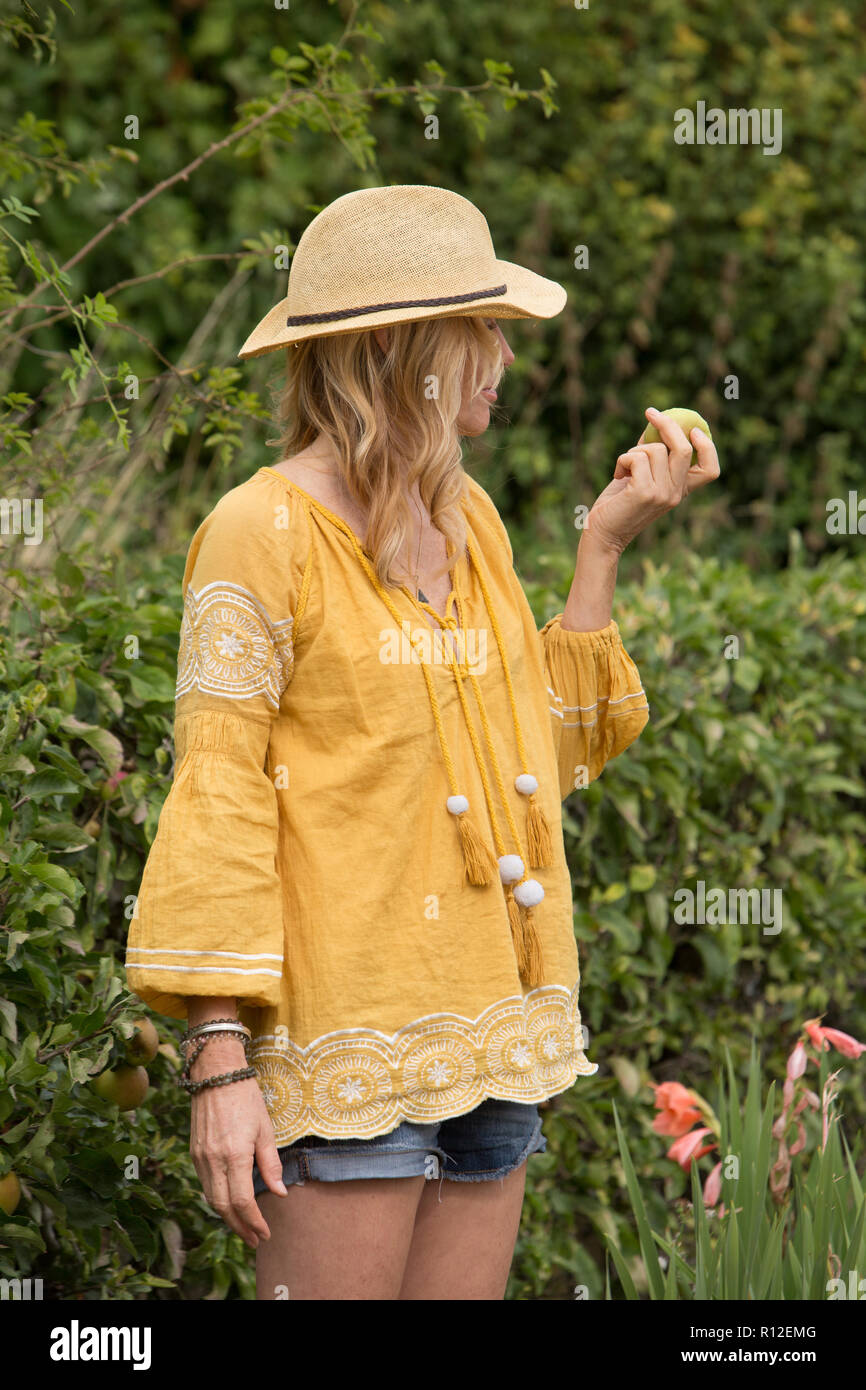 Woman eating apple from garden Stock Photo