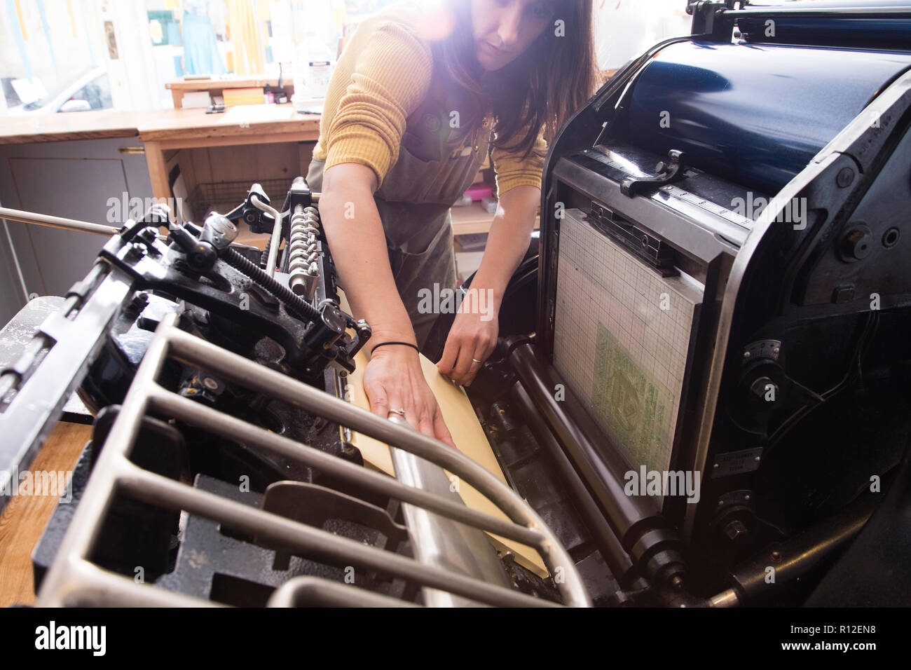 Woman preparing printer in shop Stock Photo