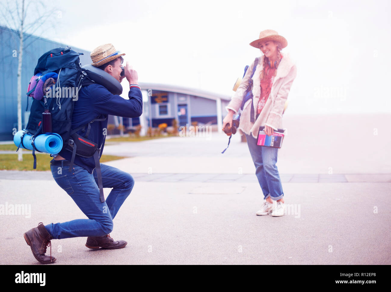 Backpacker couple taking photograph at airport Stock Photo Alamy