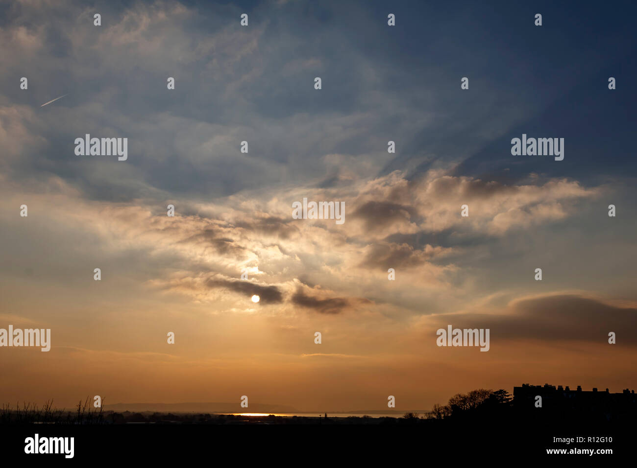 The sun breaking through the cloud-cover Stock Photo