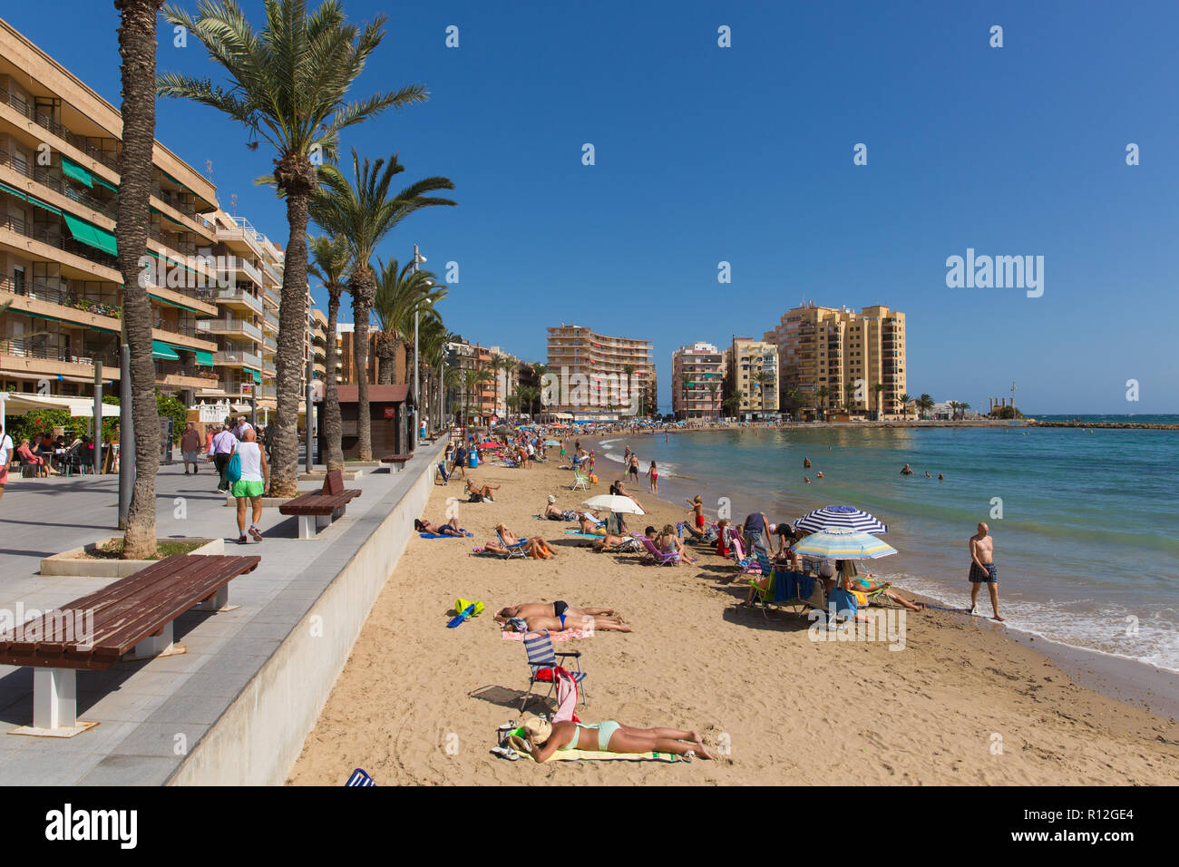 Torrevieja Spain beach with people enjoying the sunshine and good  weather at La Cura Stock Photo
