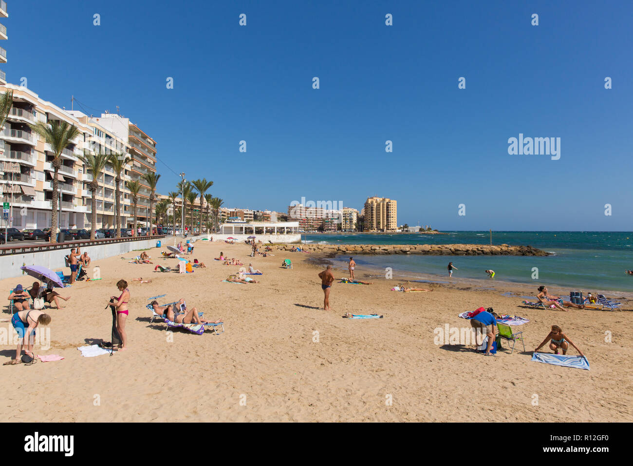 Torrevieja beach Spain with people enjoying the sunshine and good  weather at La Cura Stock Photo