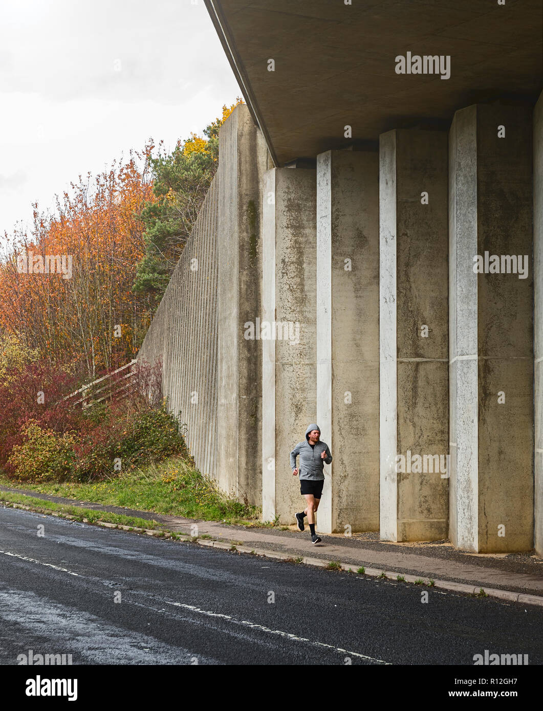 Man running by underpass Stock Photo