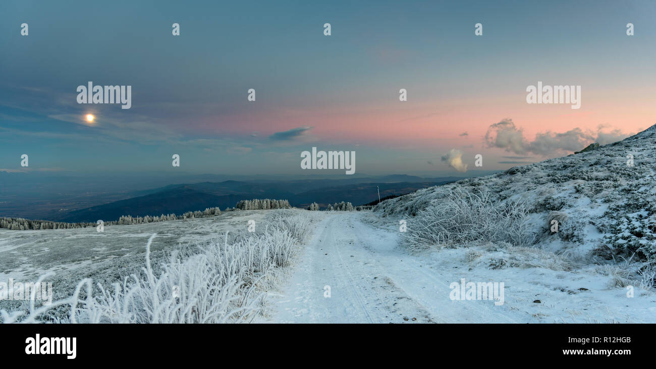 Amazing sunset on a mountain top - frozen landscape, vivid colors, cold ...