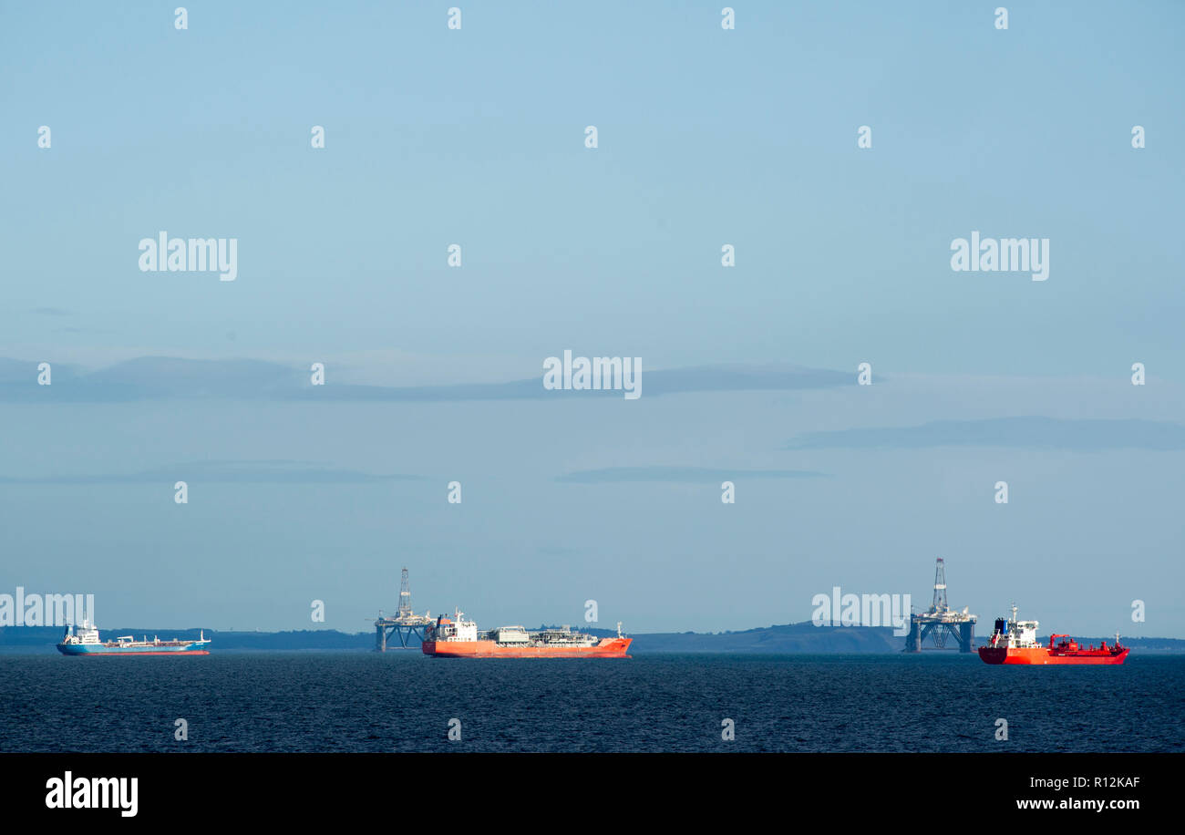 Commercial ships anchored off the east coast of Scotland in the Firth of Forth. Stock Photo